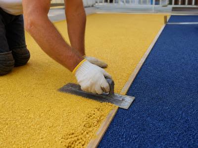 Yellow rubber being troweled at a daycare
