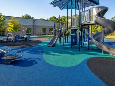 Playground with a spiral slide on rubber surfacing