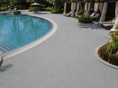 Resort pool surround in pale rubber surfacing