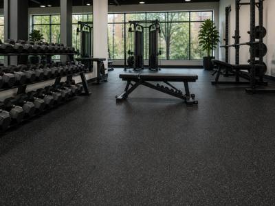 Weight room with a black rubber floor